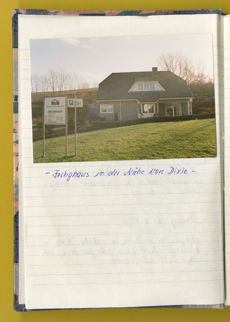 Photo: A page from a notebook featuring a photo of a prefabricated house.