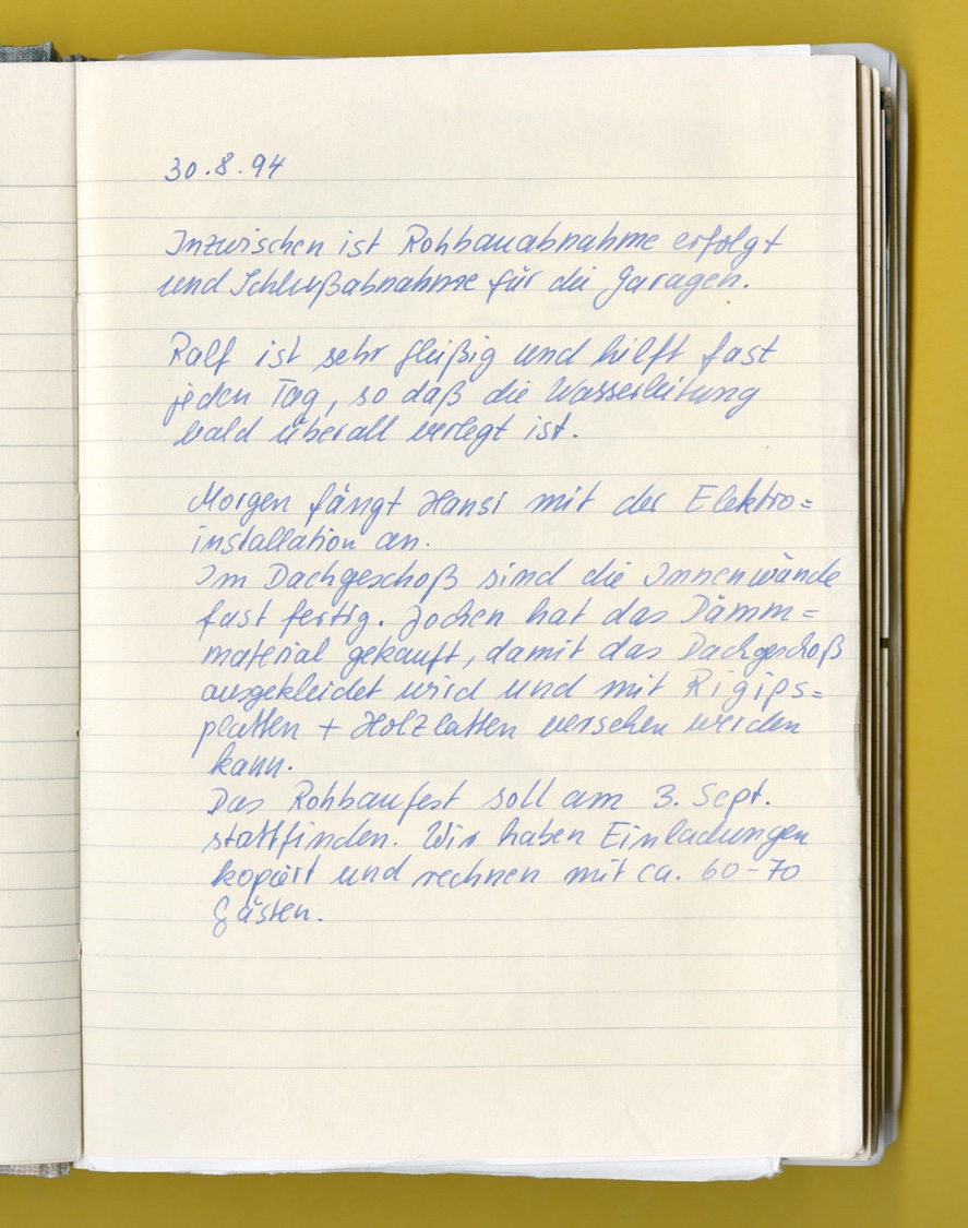 Photo: A page from a notebook with an entry noting the completion of the house in 1994.